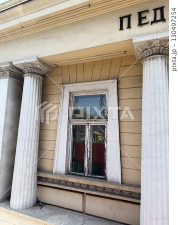 Classical columns supporting facade of an old public building. Architectural tradition, civic identity, and historic symbolism. 130497254