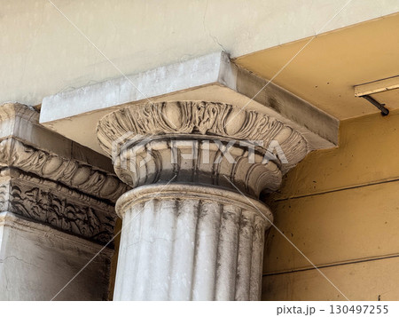 Detailed stone capital of a classical column with decorative carving. Cultural heritage, craftsmanship, and architectural history. 130497255
