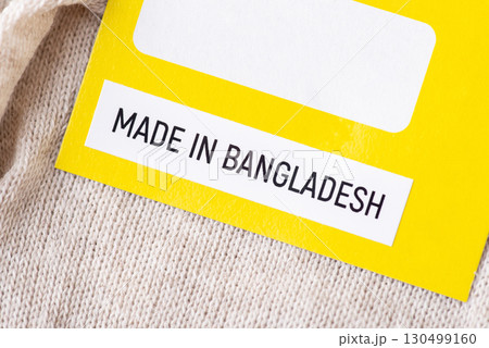 Close up on a label of socks with inscription Made in Bangladesh. Producing clothes in Bangladesh concept Close up on a label of socks with inscription Made in Bangladesh. Producing clothes in Bangladesh concept 130499160