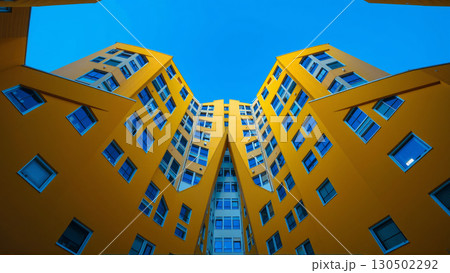 Bottom up view of bright modern yellow apartment buildings 130502292