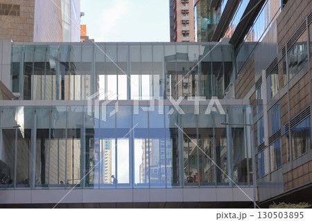 Aug 30 2025 Modern Glass Walkway Between Urban Buildings With City Views Aug 30 2025 Modern Glass Walkway Between Urban Buildings With City Views 130503895