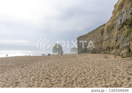 Victoria, Australia - January 1,2024 : Tourists walking on the Gibson Beach at the Twelve Apostles Marine National Park along the Great Ocean Road  in Victoria, Australia on January 1,2024. 130504094