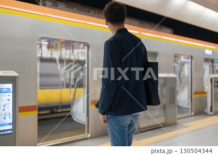 駅のホームで電車を待つ男性 駅のホームで電車を待つ男性 130504344