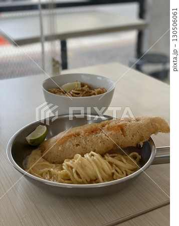 Delicious crispy fish fillet and pasta in a bowl and pan 130506061