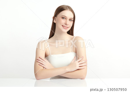 A beautiful young Asian woman with clean, fresh skin against a white background. Skincare, facial treatment, cosmetology, beauty, and spa. An elegant portrait of an Asian woman. 130507950