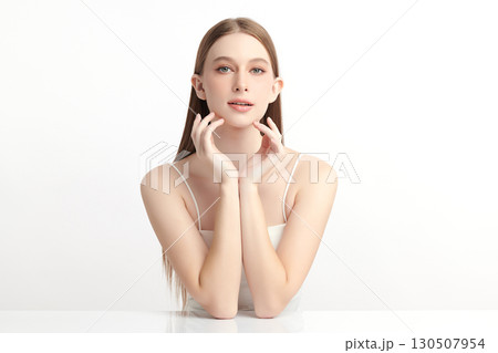 A beautiful young Asian woman with clean, fresh skin against a white background. Skincare, facial treatment, cosmetology, beauty, and spa. An elegant portrait of an Asian woman. 130507954