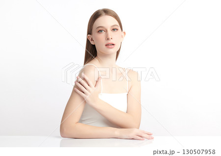 A beautiful young Asian woman with clean, fresh skin against a white background. Skincare, facial treatment, cosmetology, beauty, and spa. An elegant portrait of an Asian woman. 130507958