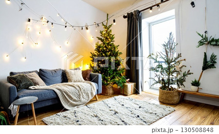 Festive Christmas Living Room with Decorated Tree Blue Sofa and Cozy Woven Rug 130508848