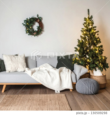 Festive Living Room with Decorated Christmas Tree Wreath and Gray Sofa 130509298