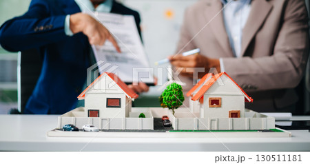 Real estate broker agent presenting and consult to customer to decision making sign insurance form agreement, home model 130511181
