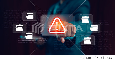 Businessman pressing digital warning alert icon with file folders on virtual screen, concept of data breach, file security, information leak, cyber risk, online fraud, malware and IT protection. 130512233