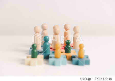 Concept of diversity, inclusion, equality is highlighted in team setup, wooden elements, symbolizing leadership, authority, influence, strong communication skills, inclusive organizational structure. Concept of diversity, inclusion, equality is highlighted in team setup, wooden elements, symbolizing leadership, authority, influence, strong communication skills, inclusive organizational structure. 130512240