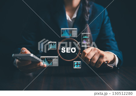 Women using magnifying glasses, computers focus on SEO analysis, search engine optimization to improve website ranking, increase internet traffic, promote business websites through modern technology. 130512280