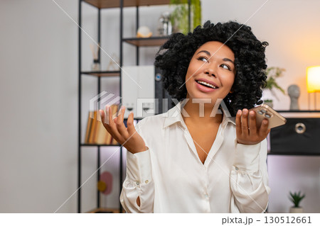 African American businesswoman on smartphone speaker gesturing happy explaining successful project 130512661
