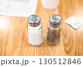レストランのテーブルの上の塩胡椒の入ったガラス瓶 130512846
