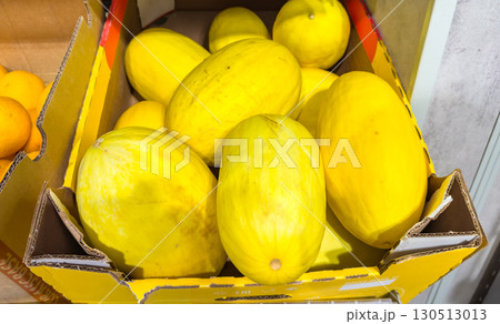Fresh ripe yellow melons in a cardboard box at the market 130513013