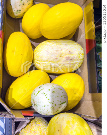 Fresh ripe yellow melons in a cardboard box at the market 130513014