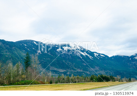 View of rural canada on Highway from Abbotsford to Hope,   BC, Canada with mountains, valleys and farms in the background 130513974
