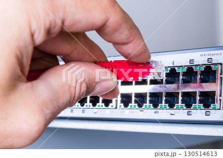 hand with red ethernet cable 130514613