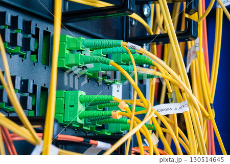 detail of server rack with fiber optic cables attached to front detail of server rack with fiber optic cables attached to front 130514645