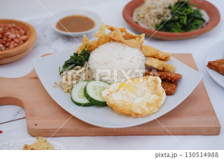 Fried Tempeh, Tofu, Egg, and Meat on Plate 130514988
