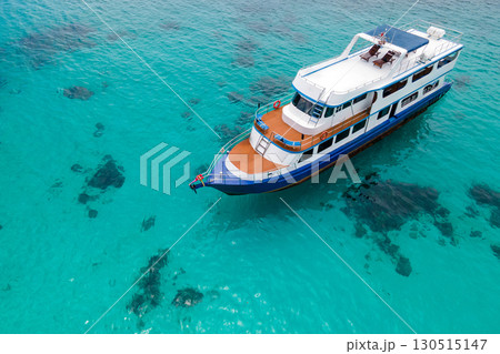 Aerial view of recreational vessel or scuba diving boat anchoring over turquoise clear water Aerial view of recreational vessel or scuba diving boat anchoring over turquoise clear water 130515147