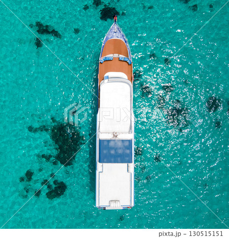 Aerial view of recreational boat anchoring over turquoise water at Racha Island in Phuket, Thailand 130515151