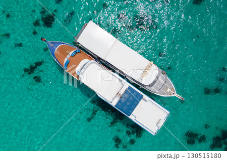 Aerial view of two boats anchoring over turquoise clear water at Racha Island in Phuket, Thailand. 130515180