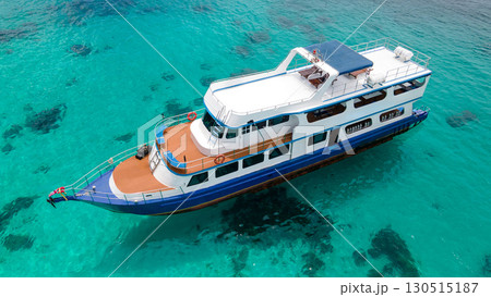 Aerial view of diving boat over turquoise clear water at Racha Island in Phuket, Thailand. Aerial view of diving boat over turquoise clear water at Racha Island in Phuket, Thailand. 130515187