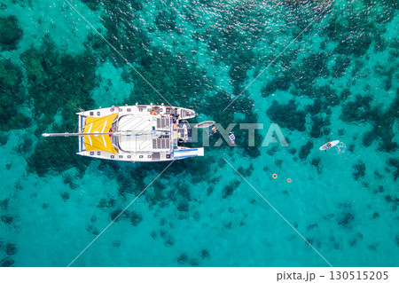 Aerial top view of sailing catamaran anchor over turquoise water Aerial top view of sailing catamaran anchor over turquoise water 130515205