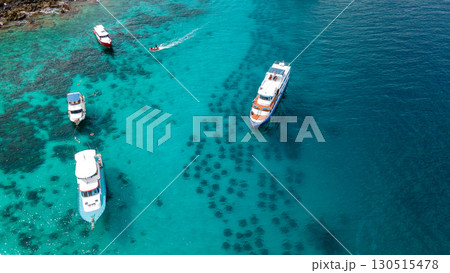 Aerial view of Racha Yai Island with tour boats in the bay Aerial view of Racha Yai Island with tour boats in the bay 130515478