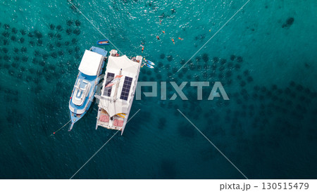 Aerial view of tour boat and catamaran anchoring over the artificial reef at Racha Yai Island Aerial view of tour boat and catamaran anchoring over the artificial reef at Racha Yai Island 130515479