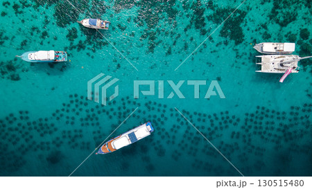 Aerial view of tourboat, yacht catamaran and diving boat anchoring over the artificial reef Aerial view of tourboat, yacht catamaran and diving boat anchoring over the artificial reef 130515480
