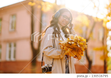 Beautiful woman taking pictures in the autumn forest. Rest, relaxation, tourism, lifestyle concept. Beautiful woman taking pictures in the autumn forest. Rest, relaxation, tourism, lifestyle concept. 130516795