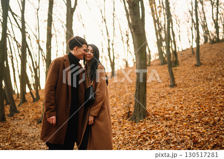 Young couple in love walking in the park on a autumn day. Enjoying time together. 130517281