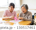 介護施設でレクリエーションを楽しむ高齢者と女性介護士 130517461