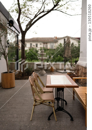 Restaurant Table Chairs outdoors provides Dining at empty terrace during the daytime for customer. 130518260