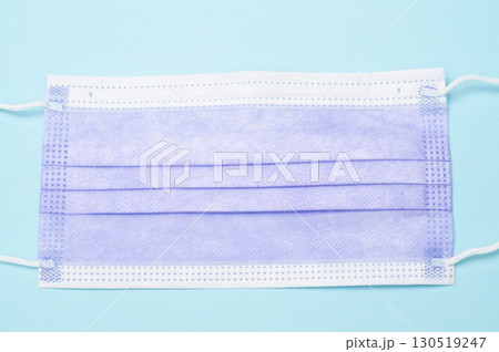 Purple medical mask, top view on blue background, healthcare, safety, and protective face mask concept 130519247