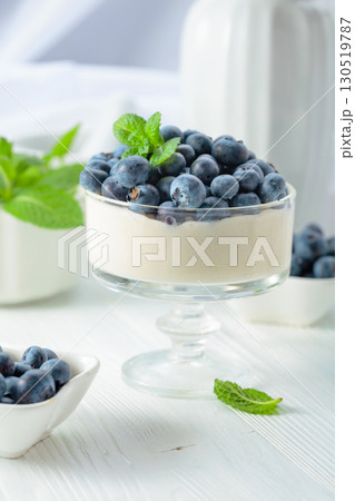 Panna cotta with fresh blueberries in a clear bowl. Panna cotta with fresh blueberries in a clear bowl. 130519787