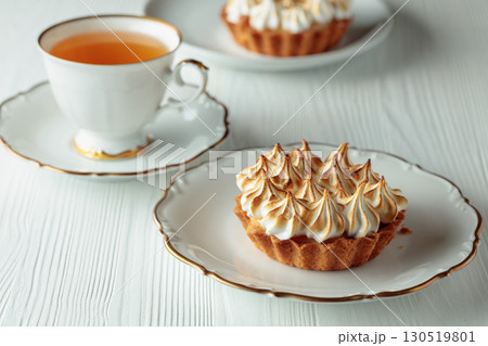 Meringue tart on a white table. Meringue tart on a white table. 130519801