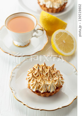 Meringue lemon tart on a white wooden table. 130519802