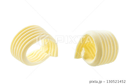 Butter curls isolated on a white background. Close-up of butter curls. Butter curls isolated on a white background. Close-up of butter curls. 130521452