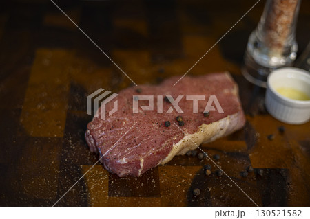 Fresh Raw Beef Steak With Rub On The Wood Board, styled for restaurant marketing, cooking shows, and premium food photography projects. Fresh Raw Beef Steak With Rub On The Wood Board, styled for restaurant marketing, cooking shows, and premium food photography projects. 130521582