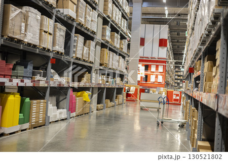 Inside A Warehouse With Rows Of Shelves 130521802