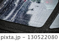 Raindrops on car windows create a blurred reflection of the city street during a rainy afternoon 130522080