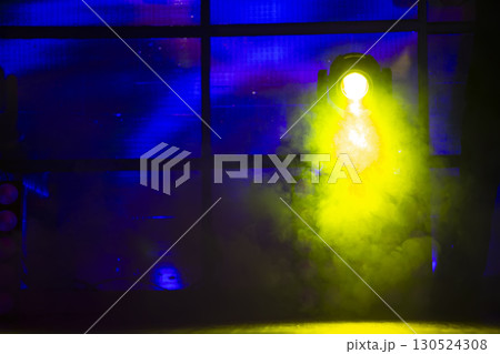 Smoke yellow from a stage smoke machine on a dark background. 130524308