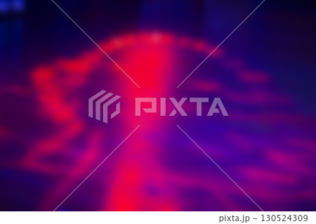 Blurred dark purple background with bright pink spots. 130524309