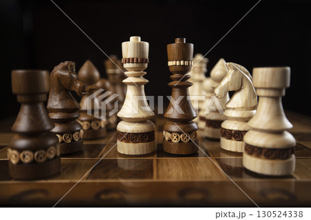 Chess on a dark background. A puzzle game with tricky combinations that requires planning and thinking. 130524338