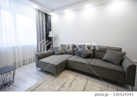 Part of the room interior with a gray corner sofa. 130524345