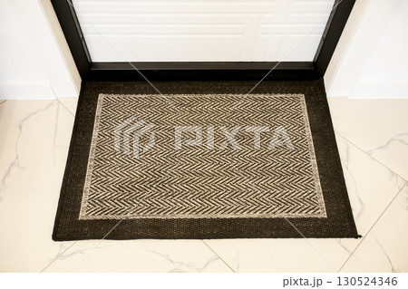 The beige floor mat is on the floor. The beige floor mat is on the floor. 130524346